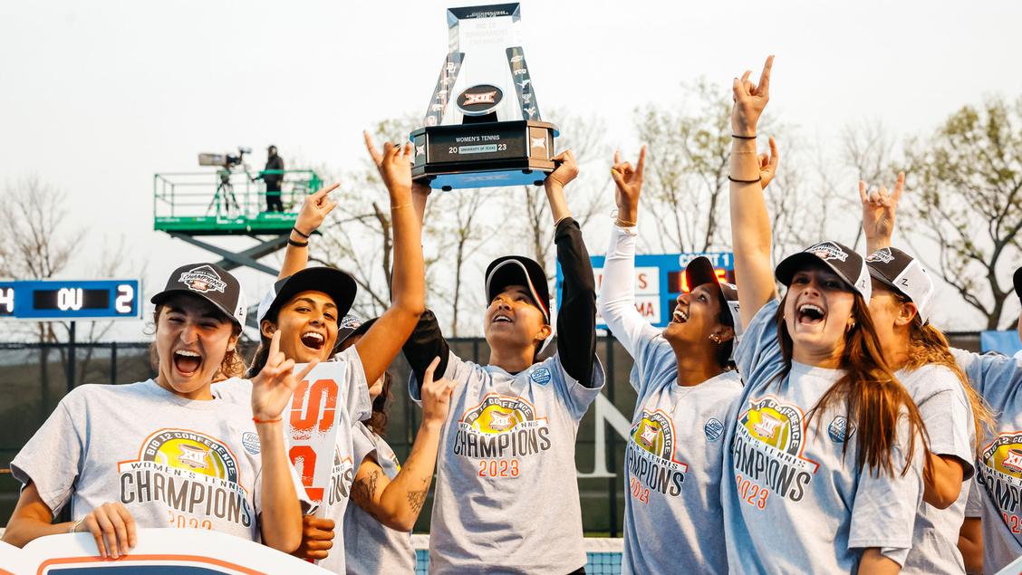 Zeylanova and team celebrate expessing UT pride with the hook'em sign and lifting of their hard won trophy