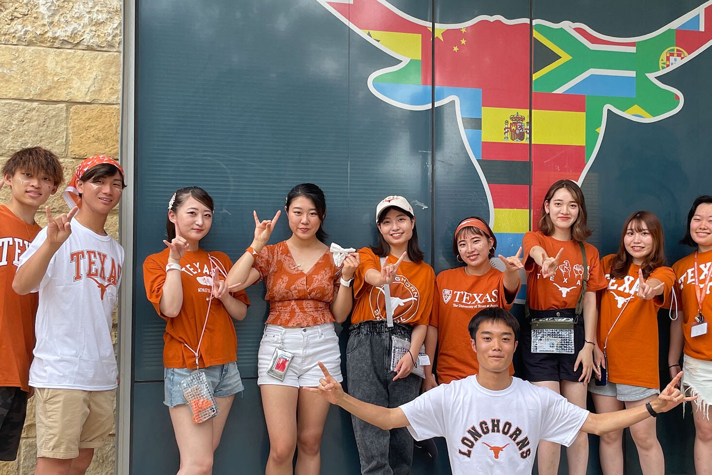 ELC students pose for a photo in front of the Texas Global Longhorn symbol showing off their Longhorn pride