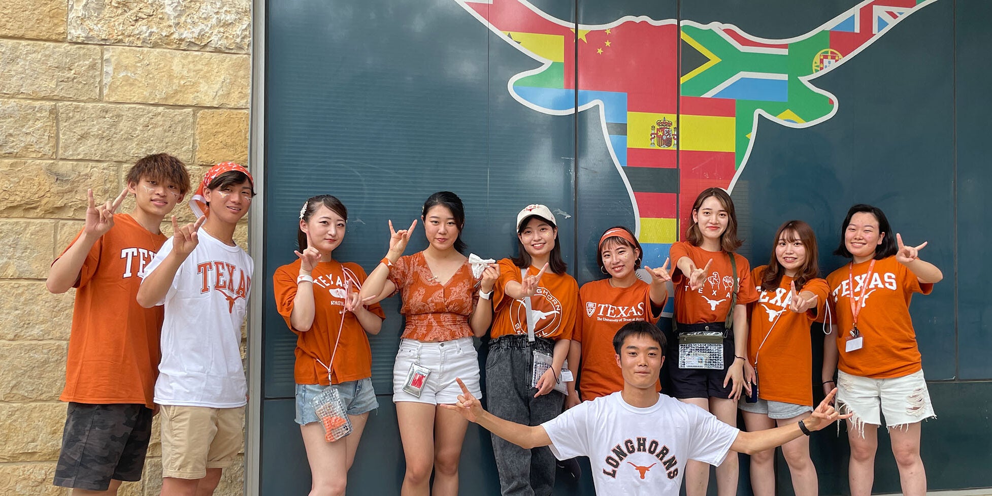 ELC students pose for a photo in front of the Texas Global Longhorn symbol showing off their Longhorn pride