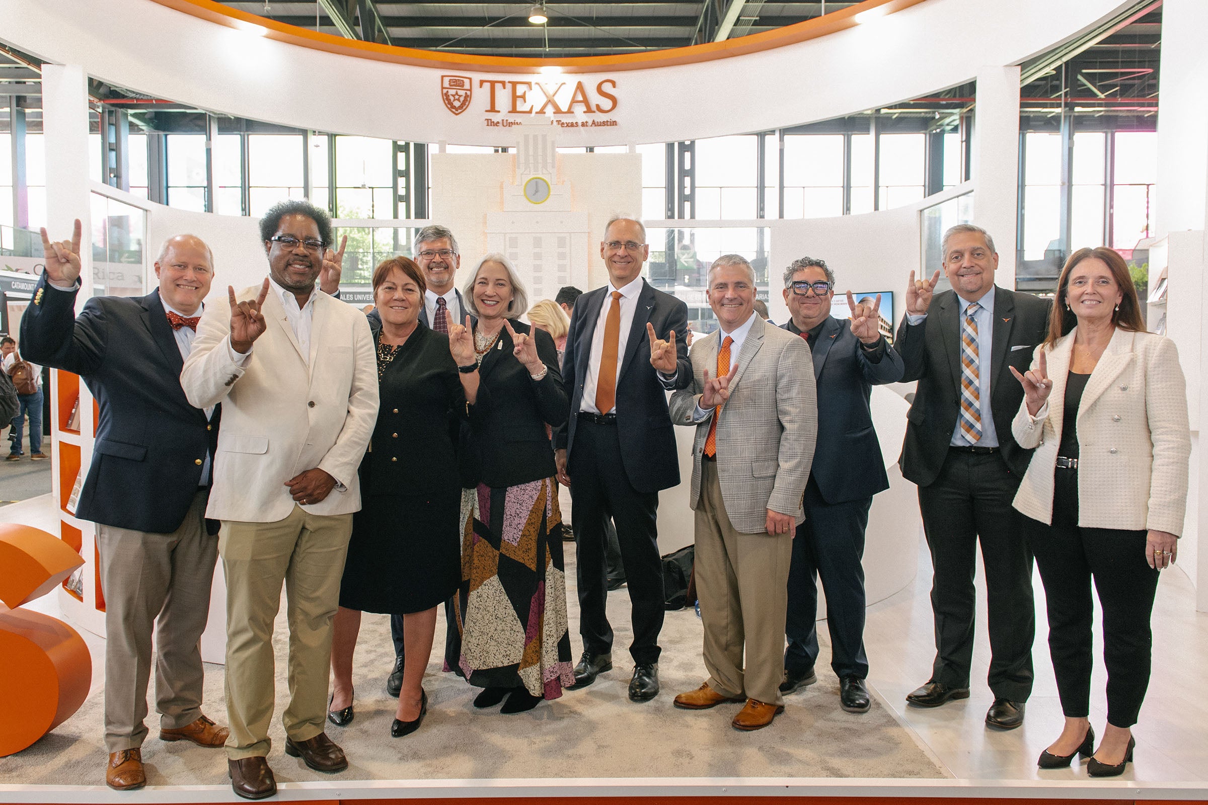 Deans from UT Austin’s colleges and schools in a group shot showing their Longhorn pride at FILUNI 2023