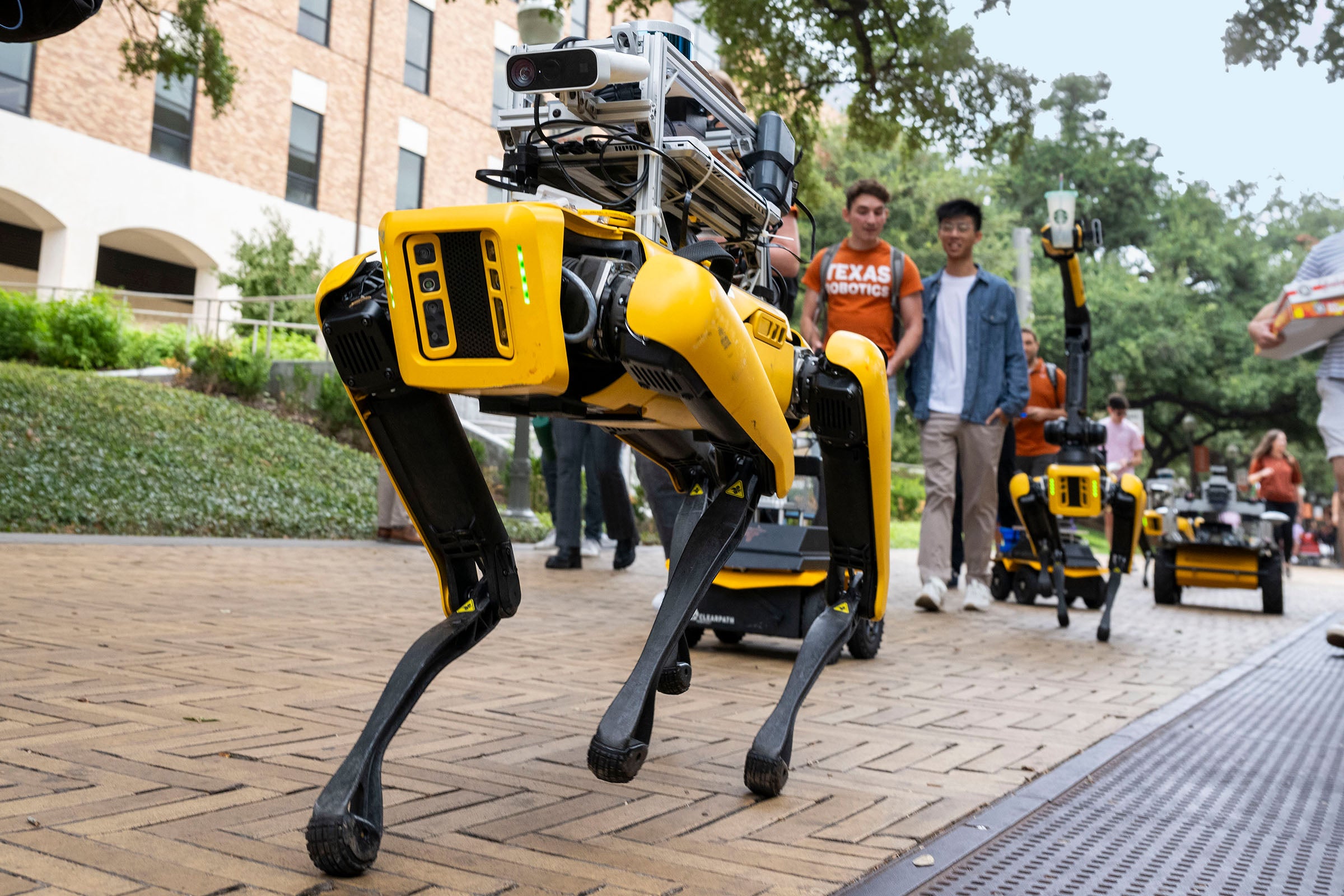 Robots walk down Speedway at UT Austin